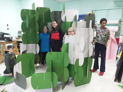 kids playing with moad system cardboard room dividers