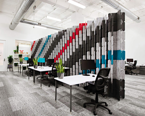 office with tall acoustic partition in colorful stripes