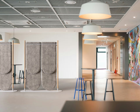 open office with quilted room dividers and murals