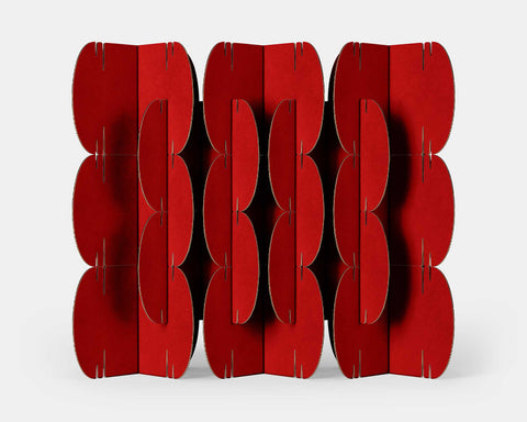 Nomad System room divider with 26 red cardboard modules creating a bold and vibrant space separation solution