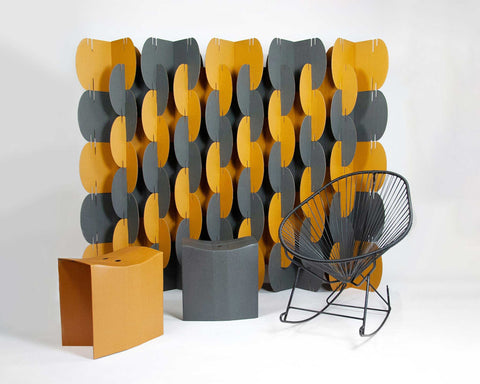 Nomad System room divider used with matching cardboard stools and rocker in a multifunctional modern space