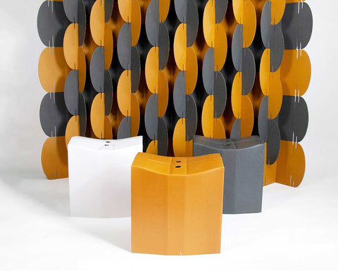 Nomad System room divider screen paired with matching cardboard stools for coordinated sustainable design
