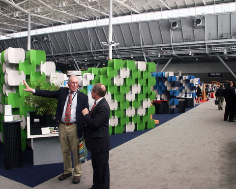 Nomad System room divider creating professional trade show booth walls with custom branding potential