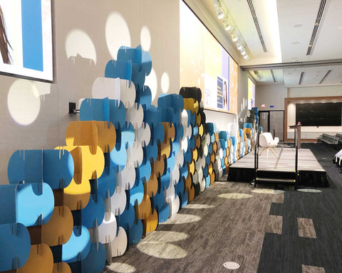 Nomad System room divider configured as an event stage screen backdrop for professional presentations