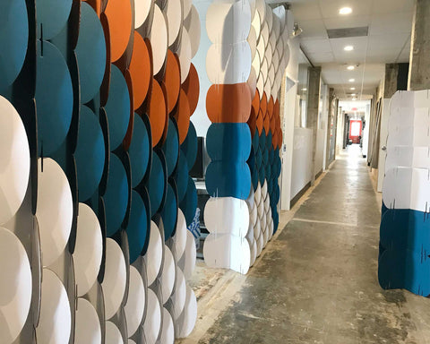 Nomad System cardboard room divider positioned as an elegant hallway screen for traffic flow management and privacy