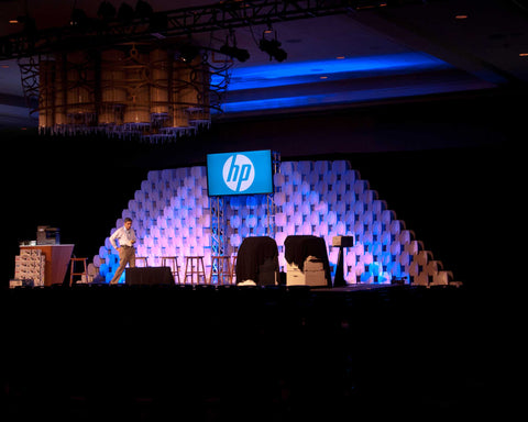 Nomad System cardboard room divider arranged in pyramid formation for dramatic stage design and decoration