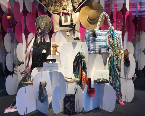 Nomad System cardboard room divider used for retail window display showcasing purses with elegant backdrop