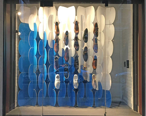 Nomad System room divider integrated into creative window display for shoes combining function and visual appeal