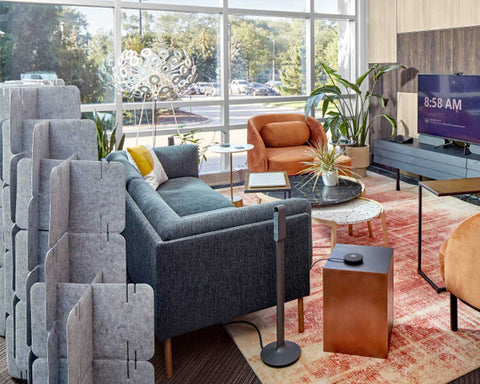 Nomad System felt room divider installed in modern living area providing elegant space division with soft textile finish