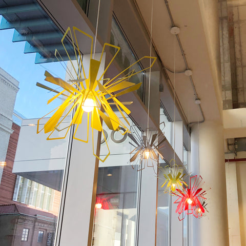 Row of Bendant lamps by large store windows.