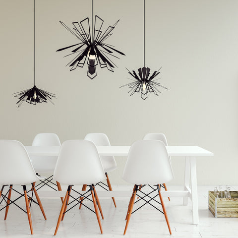 Three Black Bendant lamps over a dining table with sic chairs