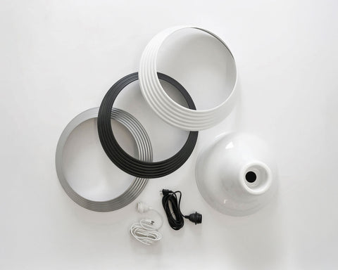 White ceiling light fixture with black and silver components on a white background