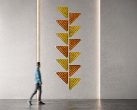 triangular wall art quilts in orange and mustard in hallway