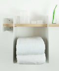 Towel rack with white towels and bathroom supplies