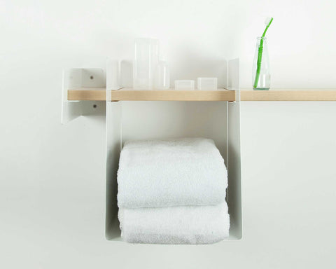 Towel rack with white towels and bathroom supplies